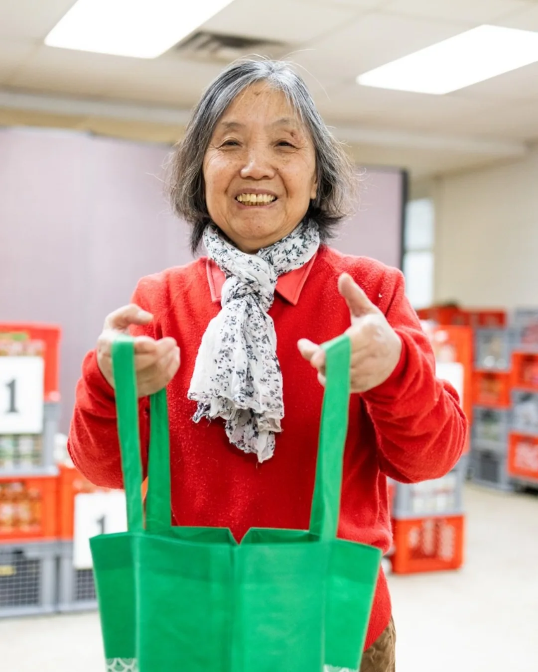 Woman holding reusable grocery bags at Scott Mission