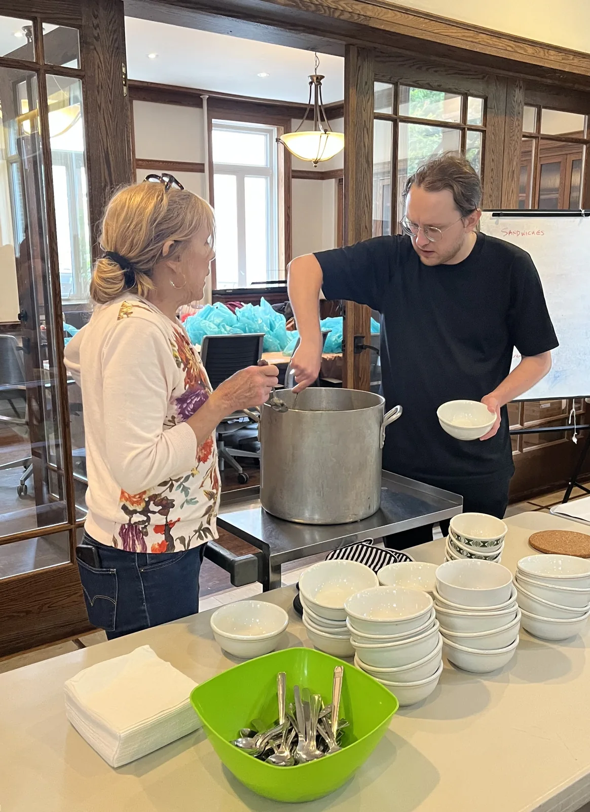 St. Thomas’s volunteers serving food beside bowls and plates