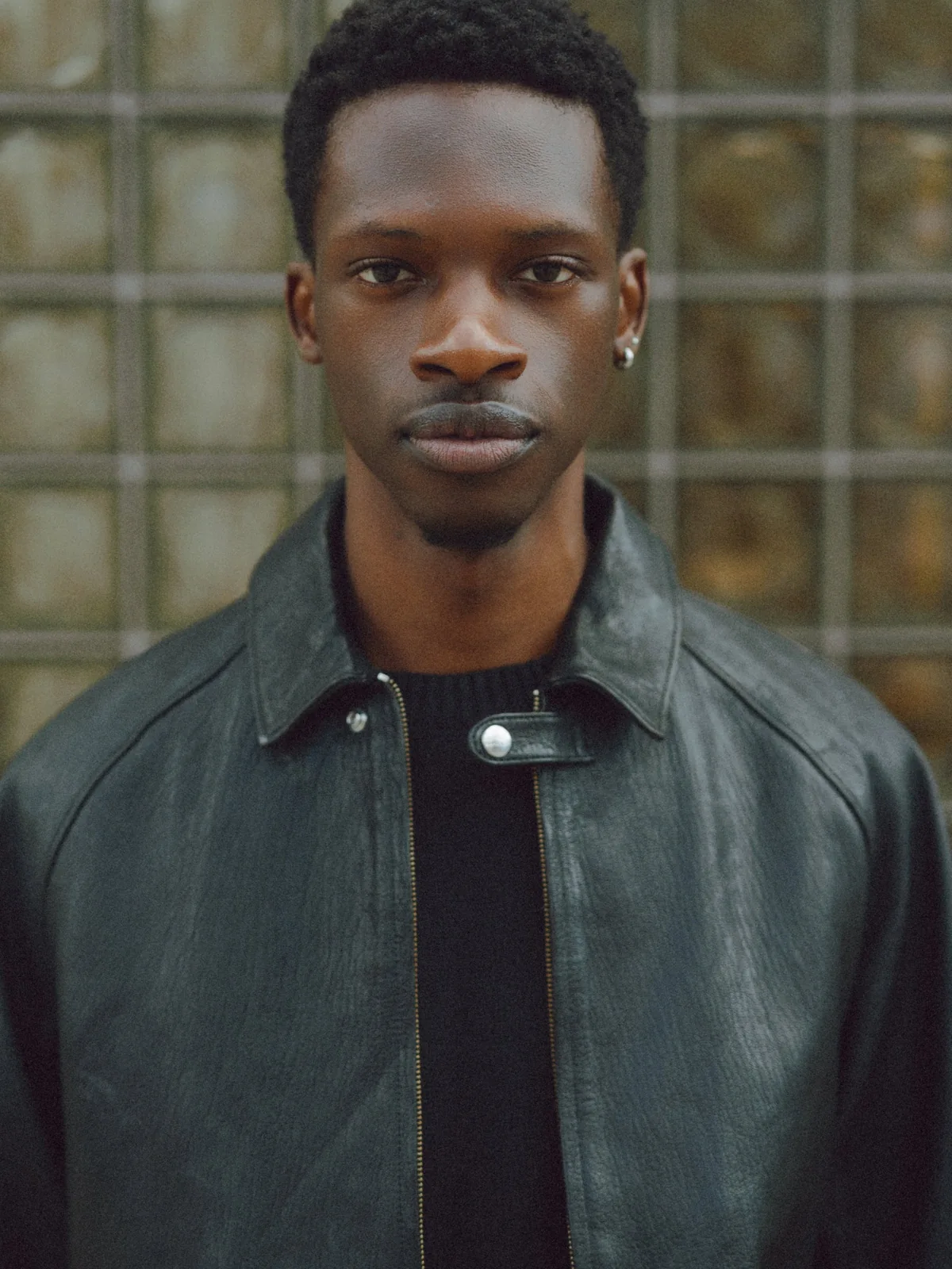 Model wearing a dark jacket in Lost & Found’s clothing photography