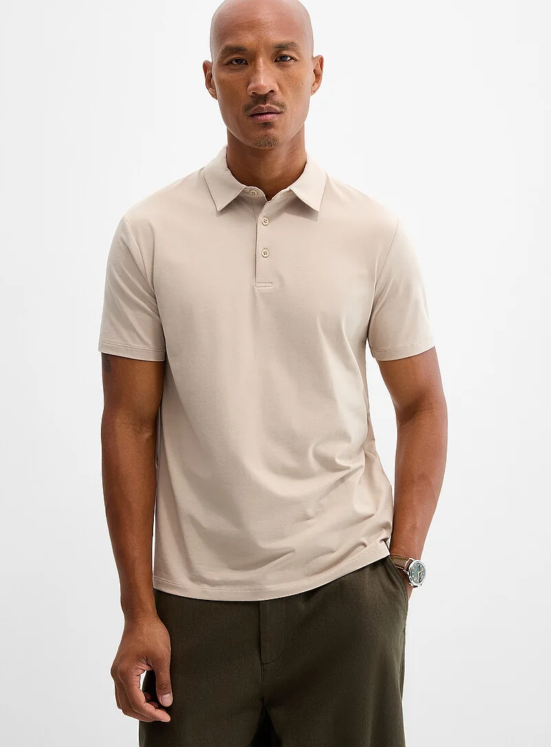 Model wearing a beige short-sleeved polo shirt