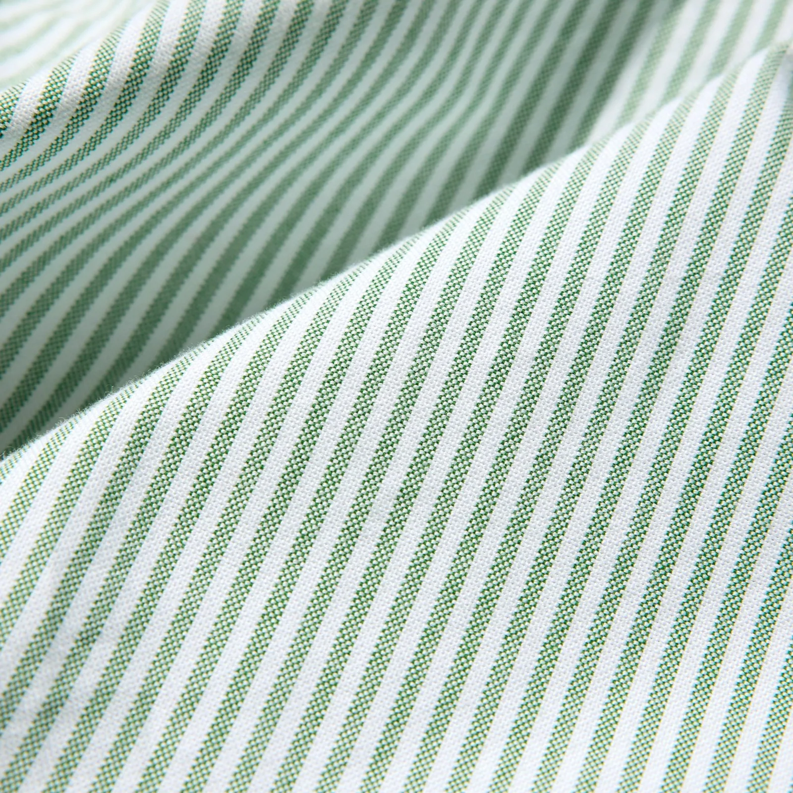 Close view of green and white striped shirt fabric