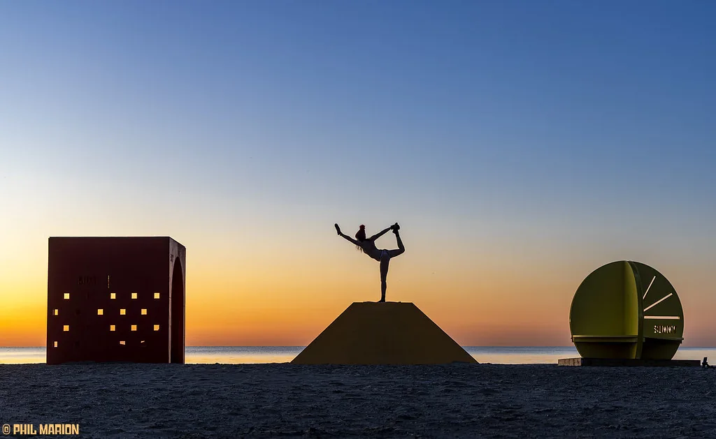 Beach structures silhouetted against a sunrise at Woodbine in March 2025