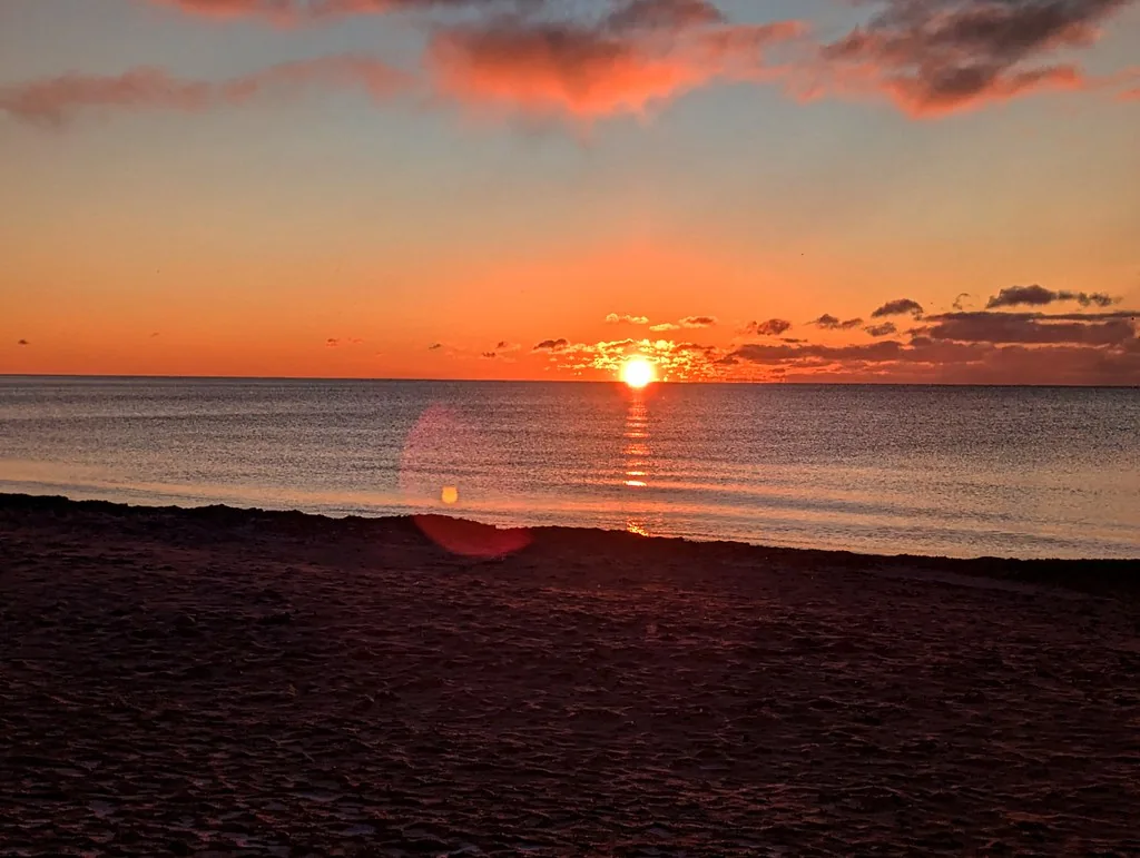 Orange sunrise over Lake Ontario from Woodbine Beach
