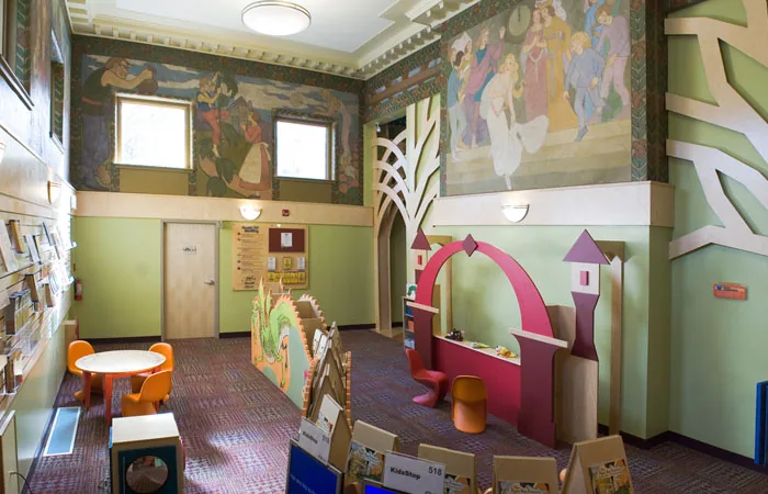 Colourful children’s reading and play corner with wall murals at Dufferin St. Clair Library