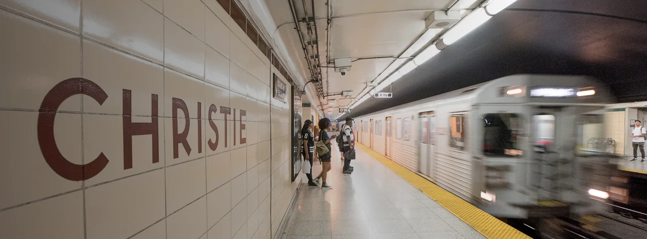 Passengers wait on the Christie Station platform as a train approaches
