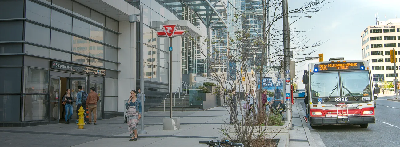 Pedestrians and a TTC bus outside Sheppard-Yonge Station
