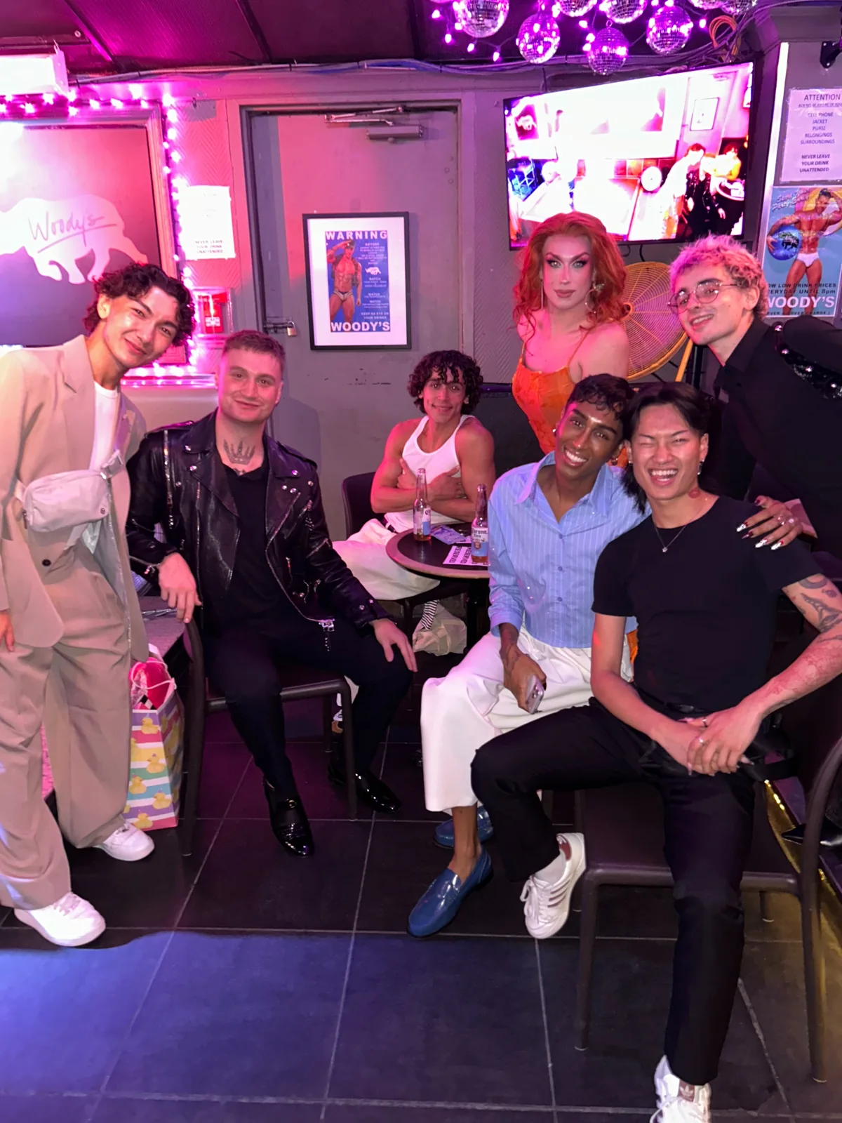 Friends at Woody's in an official Instagram photograph