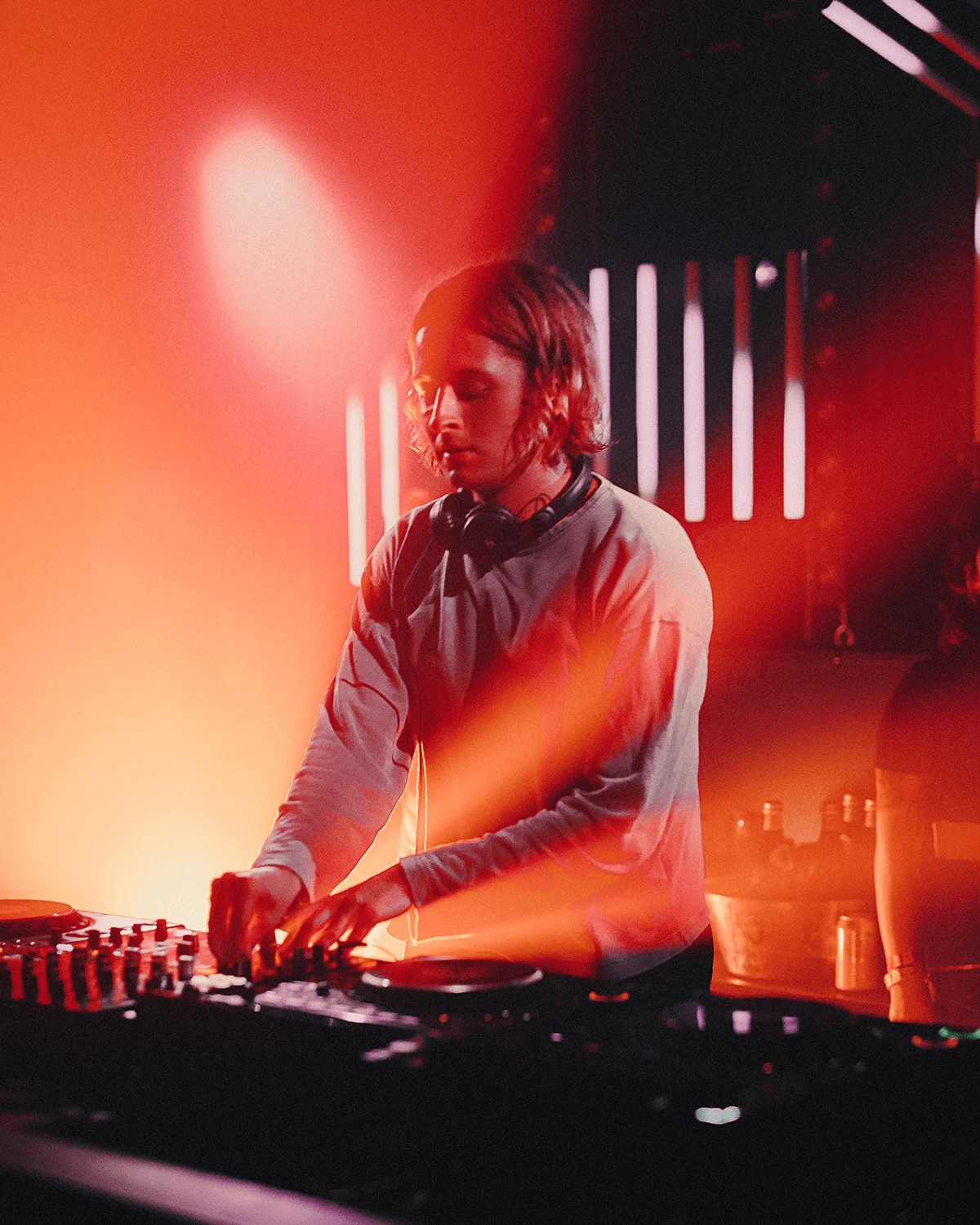 A DJ performing beside lighting inside CODA