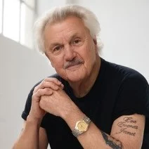 Portrait of author John Irving wearing a grey shirt