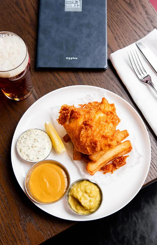 Fish and chips with a beer in The Dorset’s official photograph