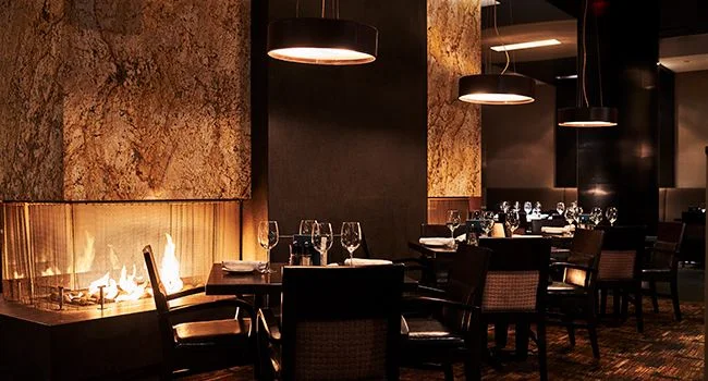 A dining room in The Keg’s official happy-hour image