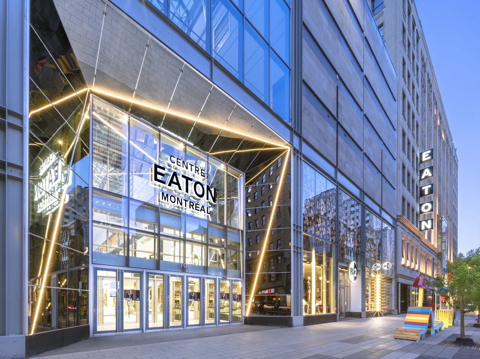 The glass entrance to Montreal Eaton Centre at dusk